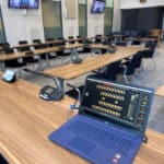 Modern conference room with digital screens and seating for professional meetings.